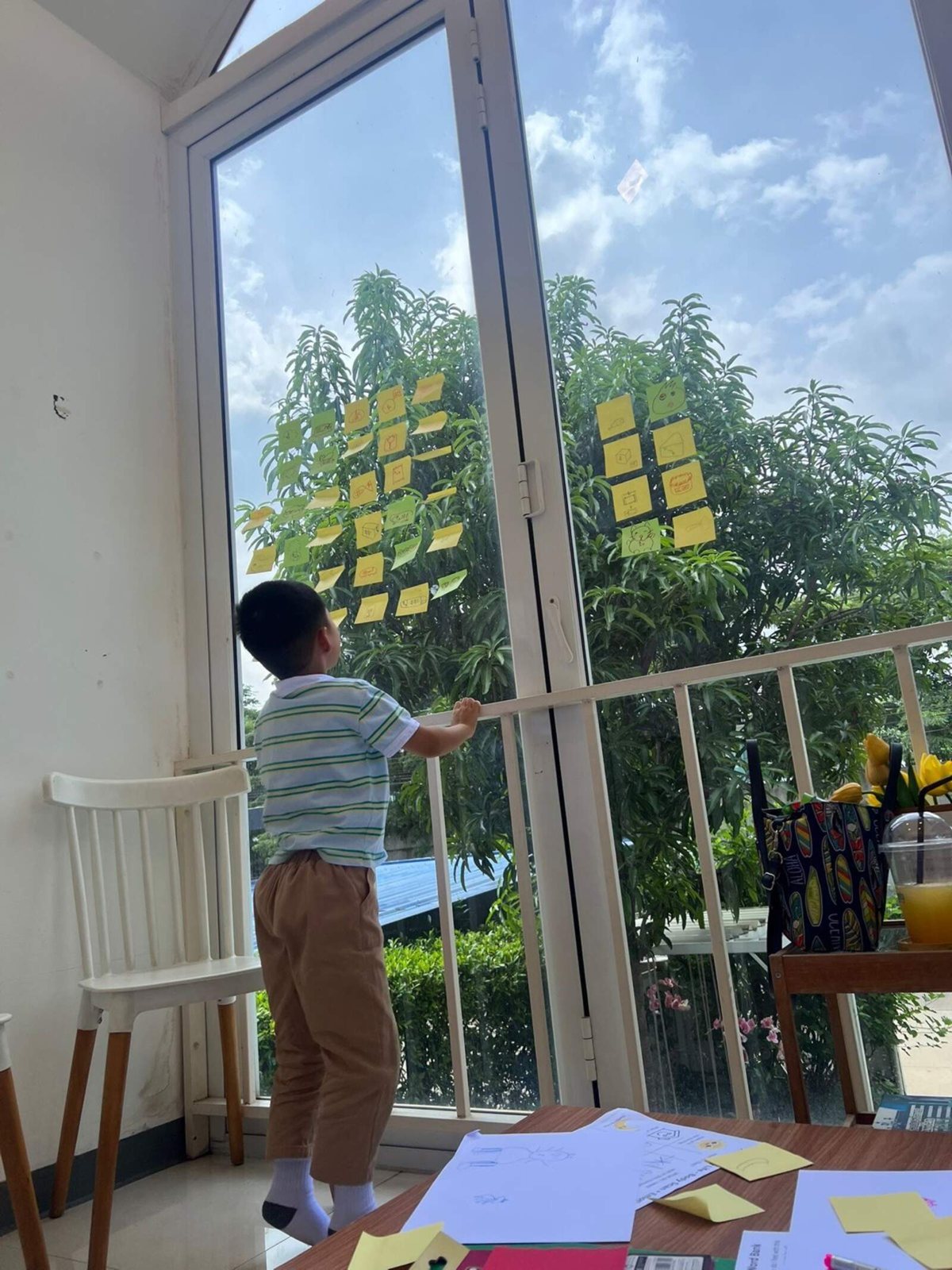 A child creating by the classroom window