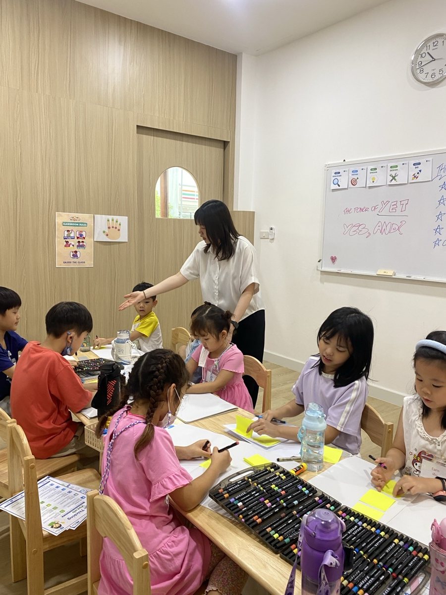 Arcko children and educators making at a classroom table