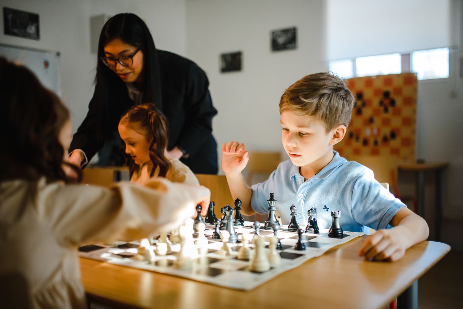A child considering a move on a chessboard
